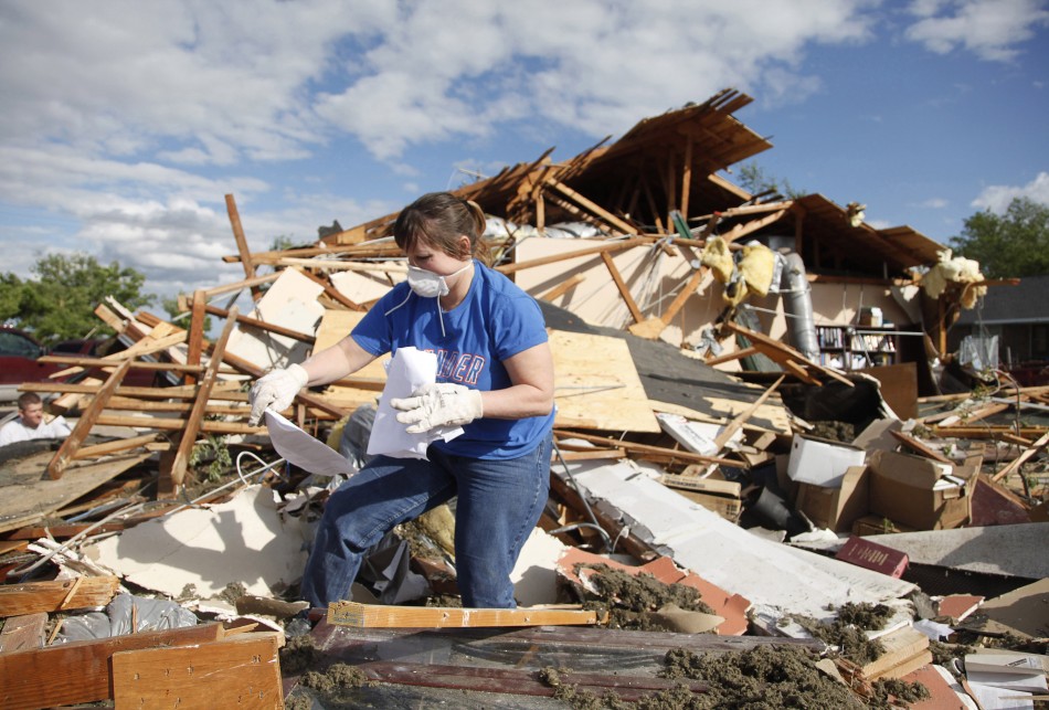 Trish Ford, of Woodward, Oklahoma, looks for personal papers for a friend whose office was destroyed by a tornado
