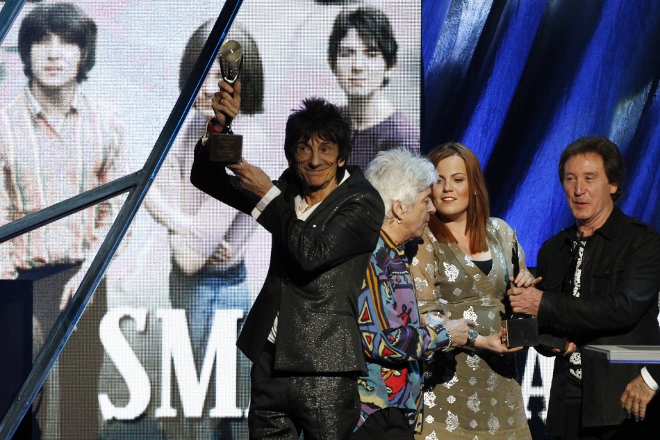 Ronnie Wood holds up the induction award as the band The Small Faces are inducted into the Rock n Roll Hall of Fame in Cleveland, Ohio