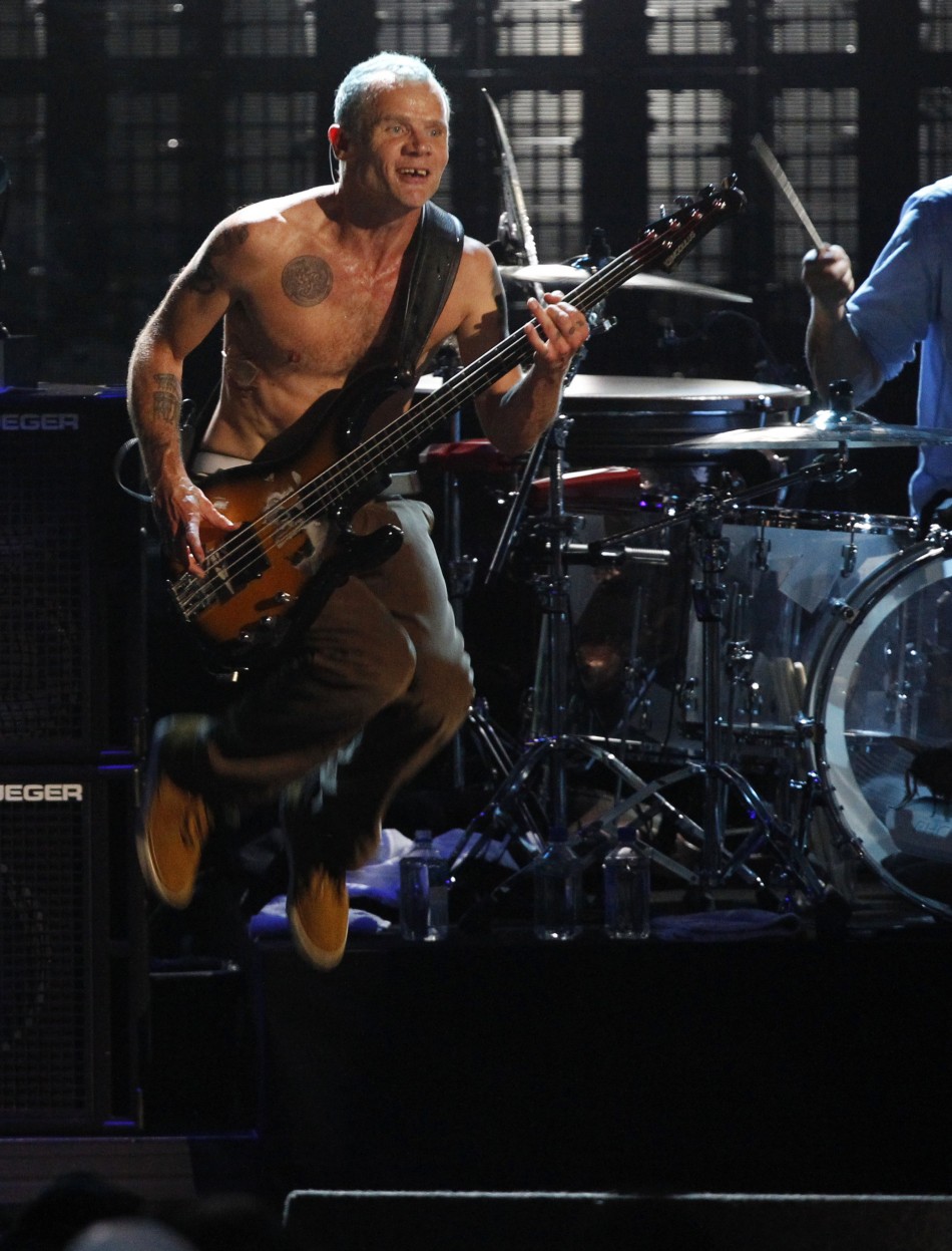 Flea from The Red Hot Chili Peppers jumps as they perform at the 2012 Rock n Roll Hall of Fame induction ceremony in Cleveland, Ohio