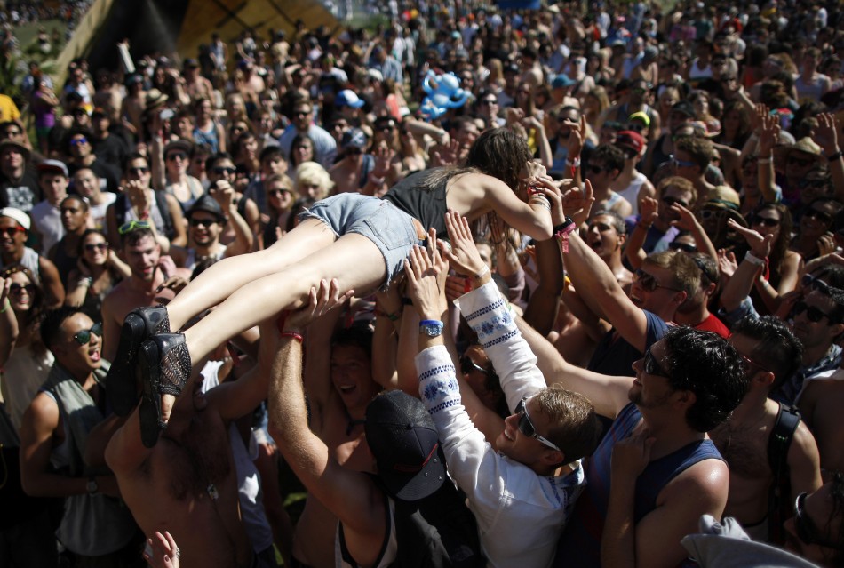 A woman crowd surfs across dancers at the Do Lab at the 2012 Coachella Valley Music and Arts Festival in Indio, California April 14, 2012.