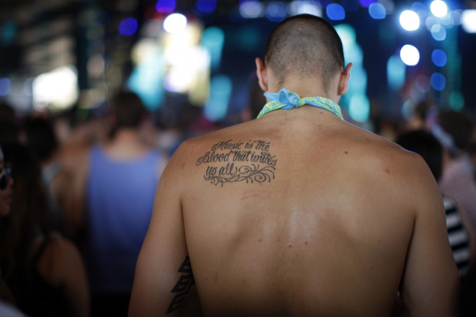 A man with a tattoo that reads quot Music is the blood that unites us allquot dances as Flux Pavilion and Doctor P plays at the 2012 Coachella Valley Music and Arts Festival in Indio