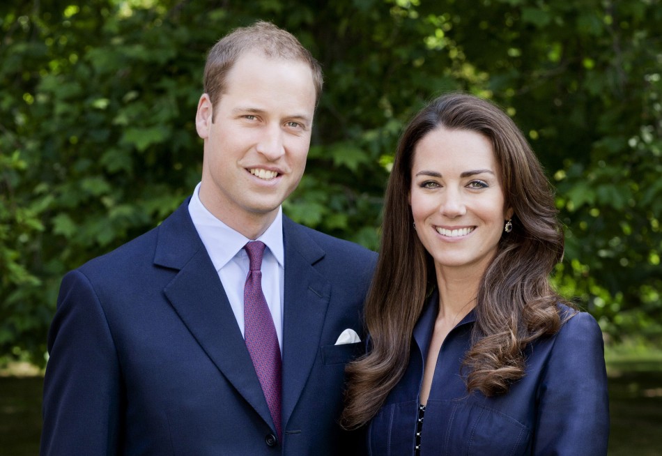 Britains Prince William and Catherine, Duchess of Cambridge pose for the official tour portrait for their trip to Canada and California, in the gardens of Clarence House in London