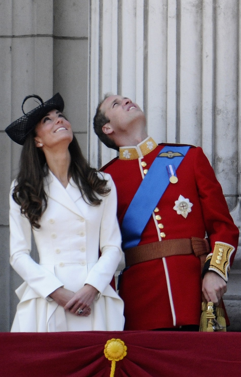 Britains Prince William and his wife Catherine, Duchess of Cambridge, watch a fly-past from the balcony of Buckingham Palace after attending the Trooping the Colour ceremony in central London