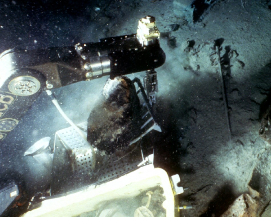 A remote-controlled robot recovers a piece of coal from the sunken luxury liner the Titanic