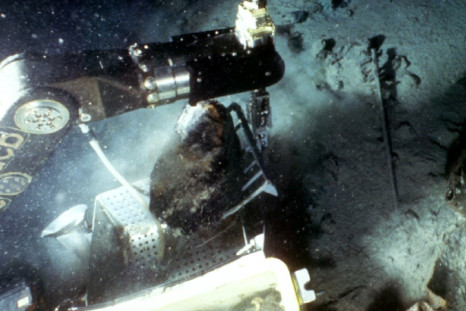 A remote-controlled robot recovers a piece of coal from the sunken luxury liner the Titanic