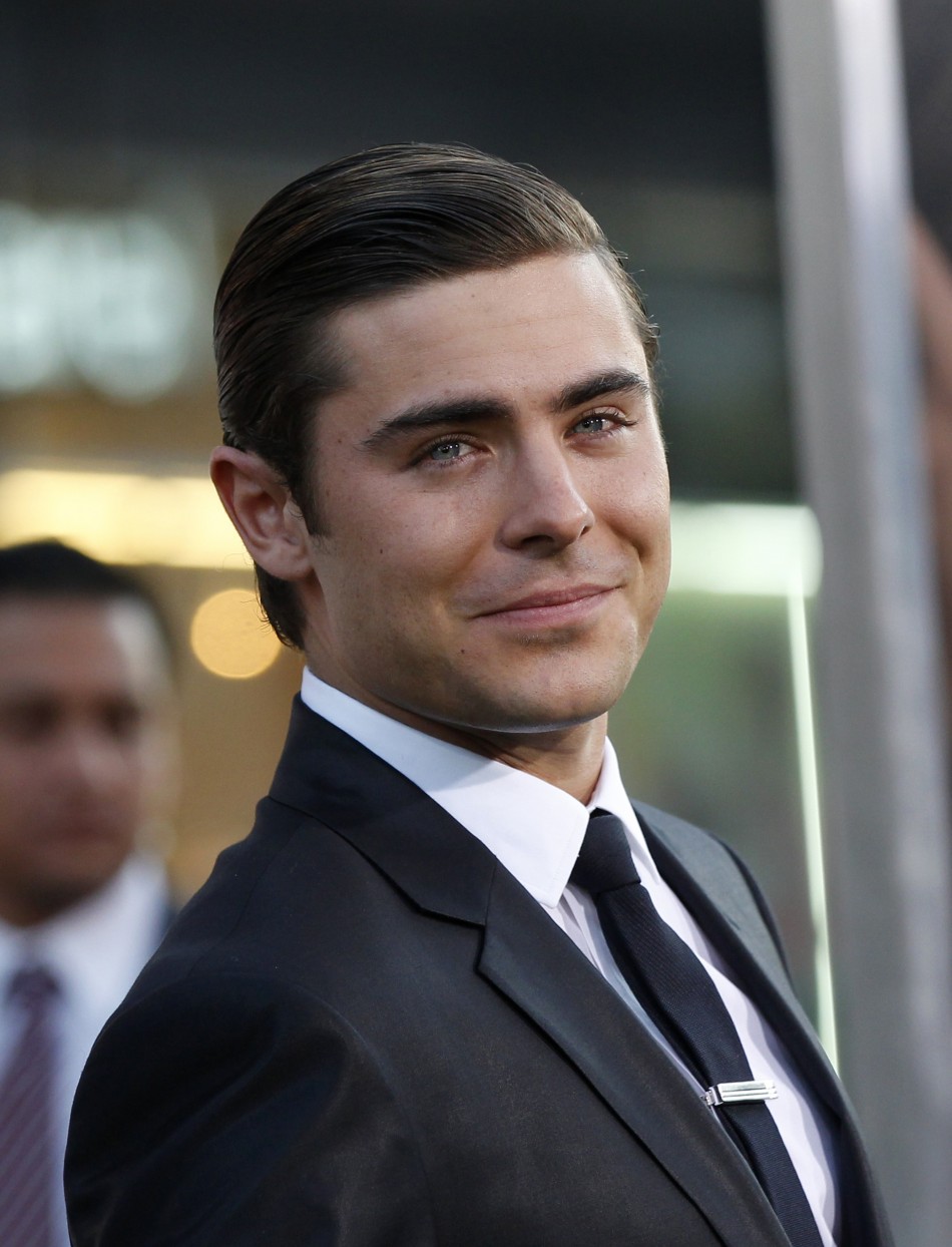 Cast member Zac Efron drops a condom from his pocket when he poses at the premiere of quotThe Lucky Onequot at the Graumans Chinese theatre in Hollywood, California April 16, 2012.