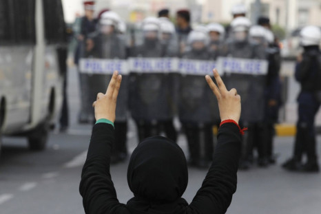 A protester flashes a victory sign during an anti-government rally in Manama