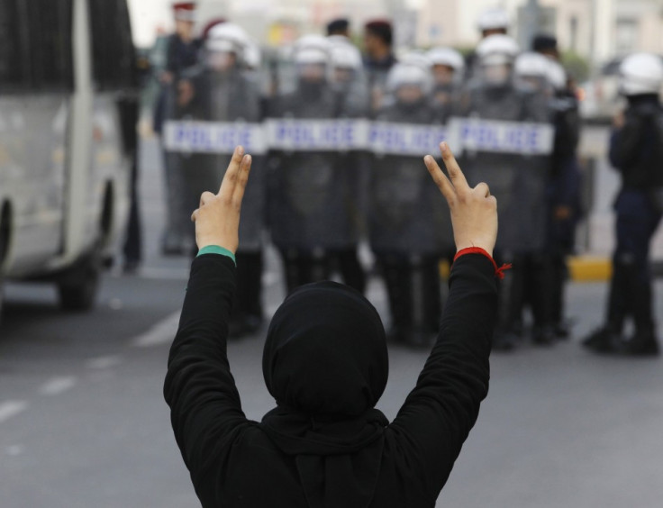 A protester flashes a victory sign during an anti-government rally in Manama