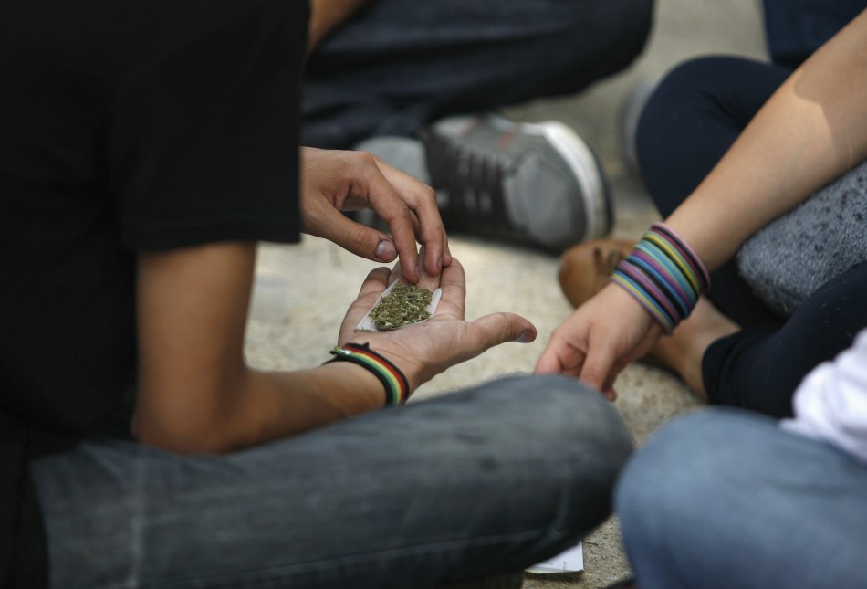 Man holds shredded marijuana in the palm of his hand during rally to demand the legalization of marijuana in Mexico City