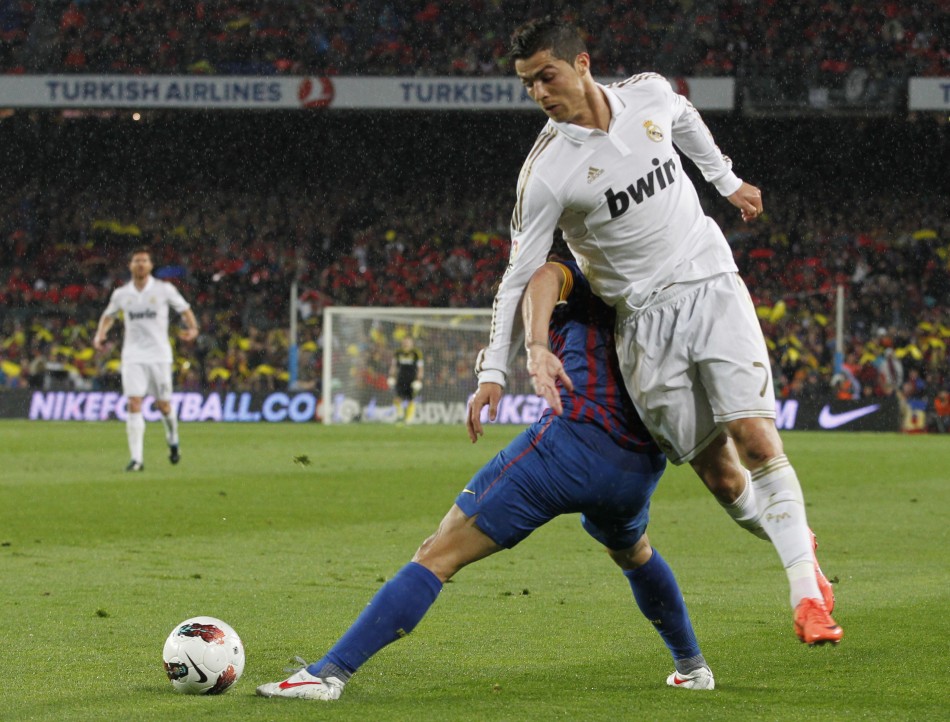 Real Madrid039s Cristiano Ronaldo tries to get past Barcelona039s Puyol during their Spanish first division soccer match in Barcelona