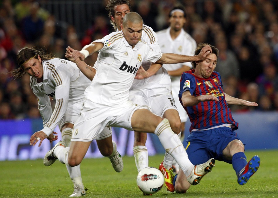 Barcelona039s Messi is challenged by Real Madrid039s Pepe, Coentrao and Ramos during their Spanish first division quotEl Clasicoquot soccer match in Barcelona