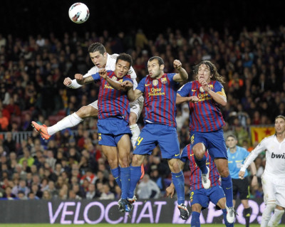 Real Madrid039s Ronaldo heads the ball surrounded by Barcelona039s Thiago, Mascherano and Puyol during their Spanish first division quotEl Clasicoquot soccer match in Barcelona Real Madrid039s Ronaldo heads the ball surrounded by Barcelona039s Thiago, Mascherano and Puyol during their Spanish first division quotEl Clasicoquot soccer match in Barcelona