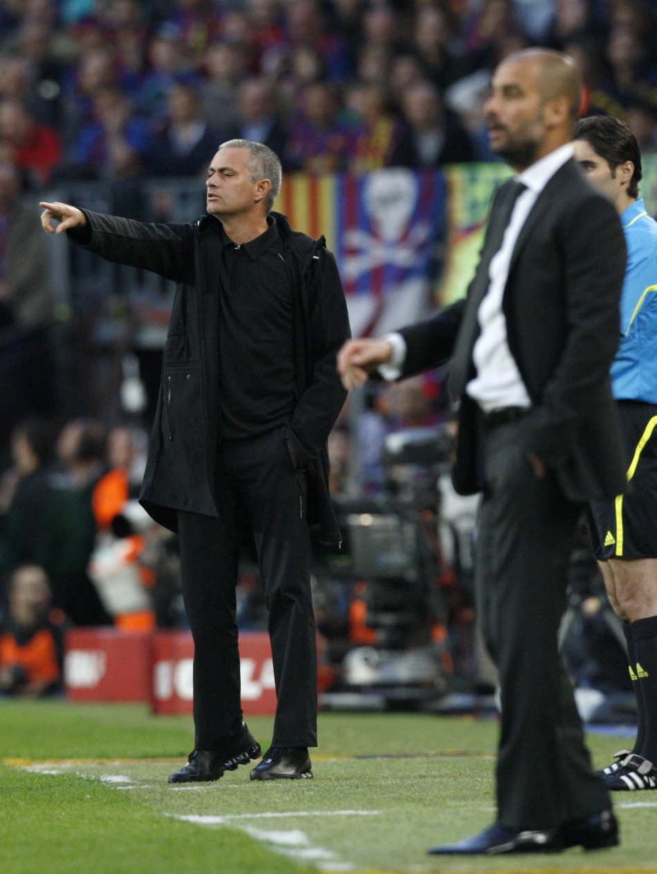 Real Madrid039s coach Mourinho gestures next to Barcelona039s cocah Guardiola during their Spanish first division soccer match in Barcelona