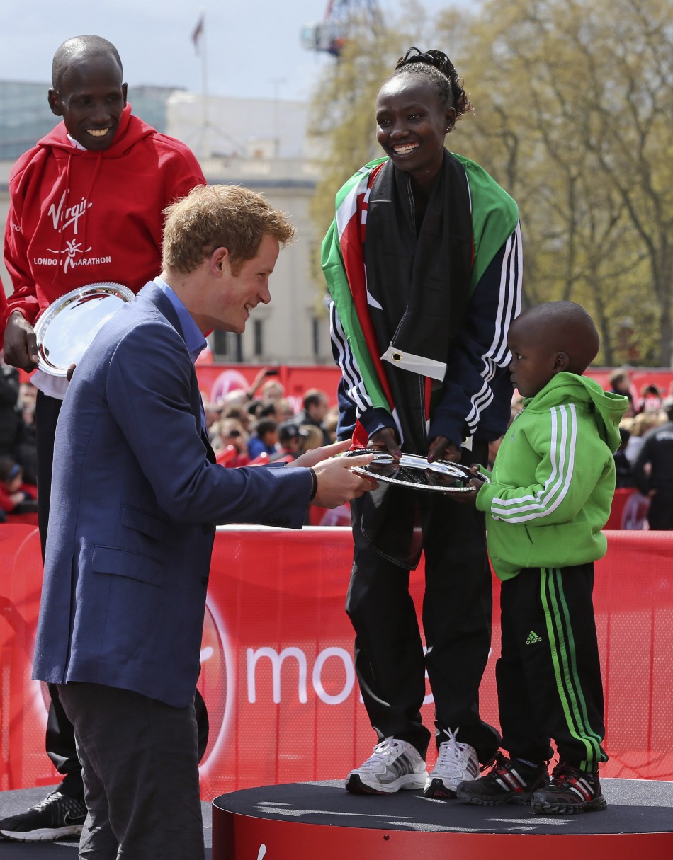Prince Harry L presents a trophy to Gerard R, the son of Kenya039s Mary Keitany