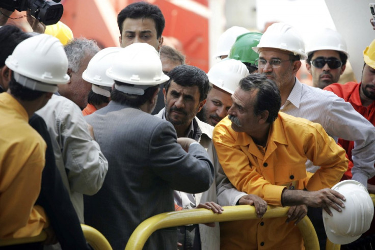 Iranian President Mahmoud Ahmadinejad listens to Seifollah Jashnaz, managing director of National Iranian Oil Company