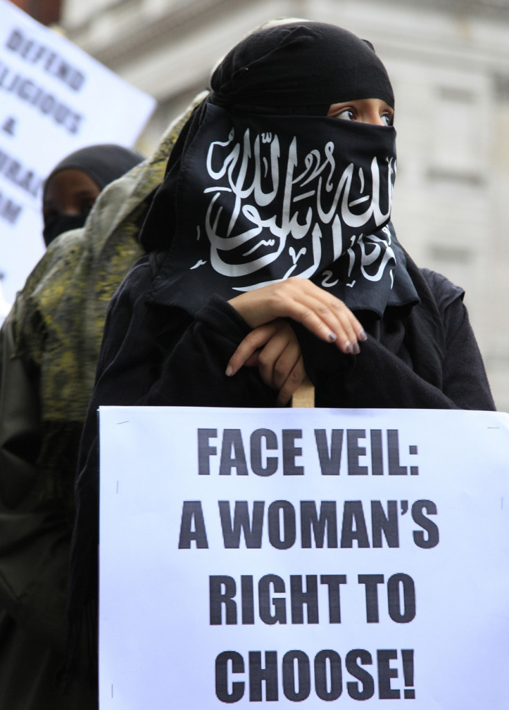 A demonstrator holds a placard during a protest outside the French embassy in London