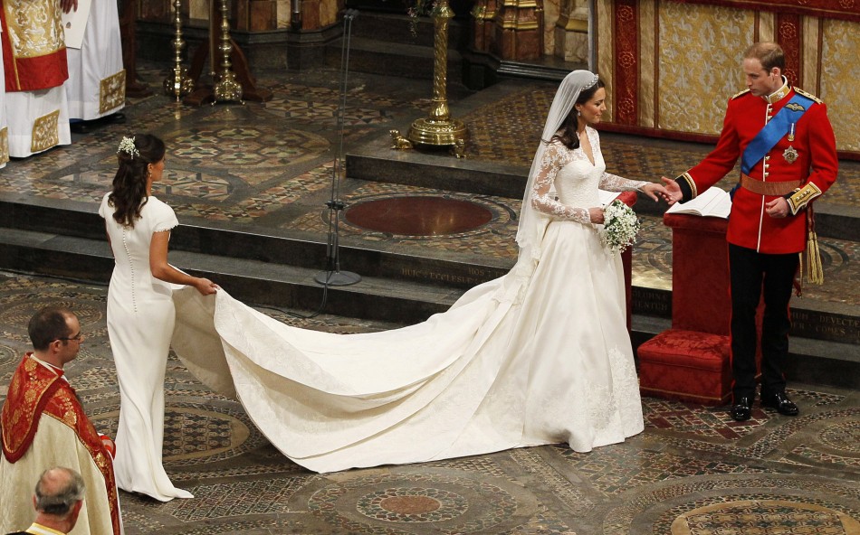 Maid of Honour, Pippa Middleton L holds the wedding dress of her sister Catherine, Duchess of Cambridge, after her she married Britain039s Prince William at Westminster Abbey, in central London