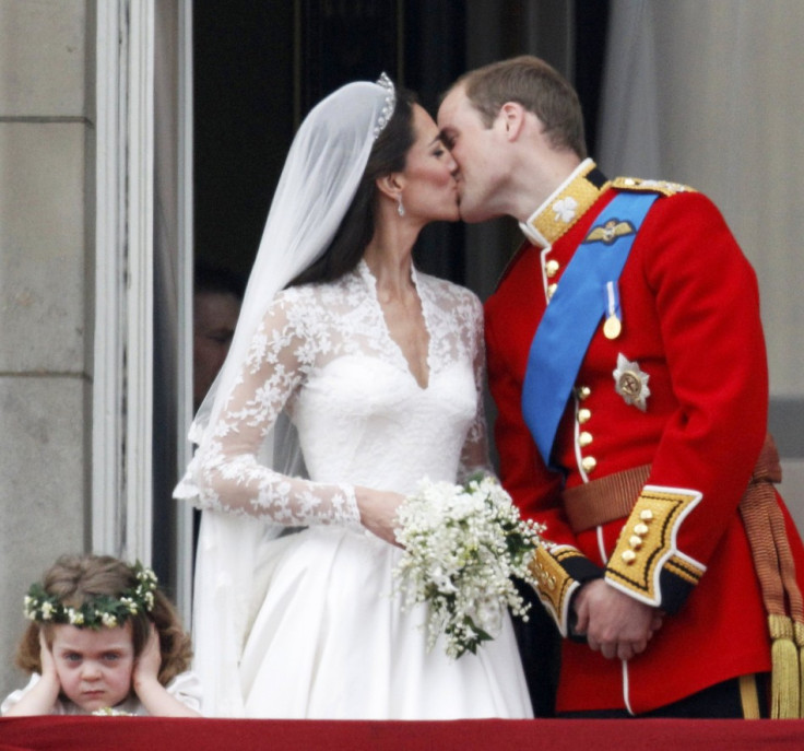 Britain's Prince William and his wife Catherine kiss as they stand next to bridesmaid Grace van Cutsem in central London