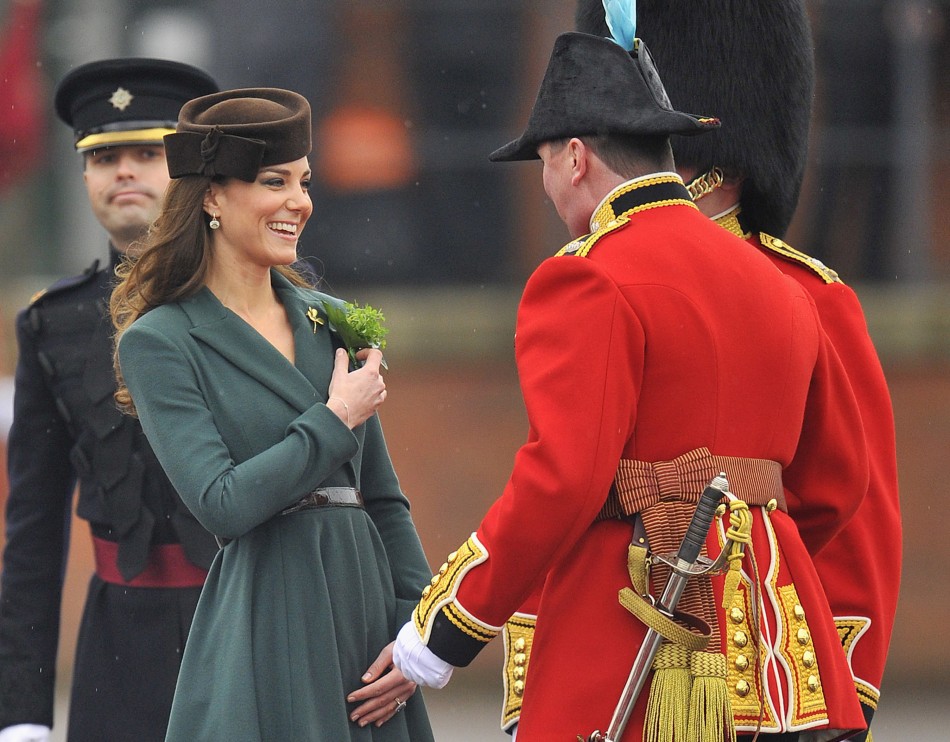 Britains Catherine, Duchess of Cambridge, presents shamrock flowers to members of 1st Battalion Irish Guards at parade ground at Aldershot army base in southern England