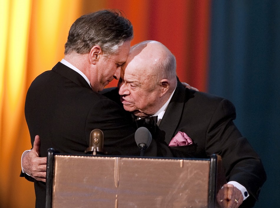 Comedian Don Rickles hugs Jon Stewart after receiving the Johnny Carson Award during the second annual 2012 Comedy Awards in New York