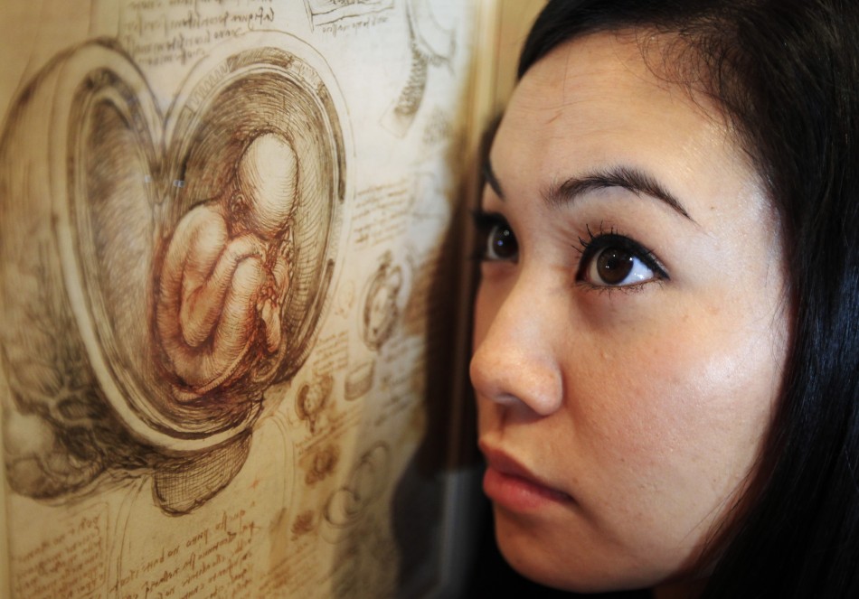 Employee Hanae Tsuji poses with artist Leonardo da Vinci039s drawing quotstudies of the foetus in the womb c.1510-13quot at the Queen039s Gallery at Buckingham Palace in London