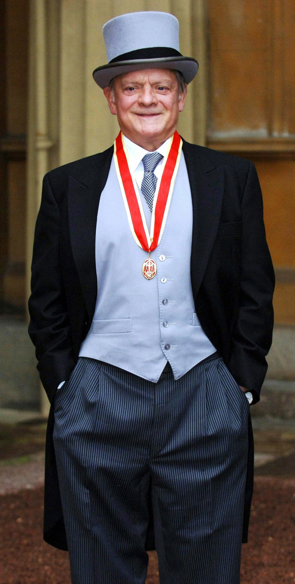 British actor David Jason stands after collecting his knighthood from Britains Queen Elizabeth II during an investiture ceremony at Buckingham Palace in central London December 1, 2005. Sir David, as he will be known, is the popular star of television