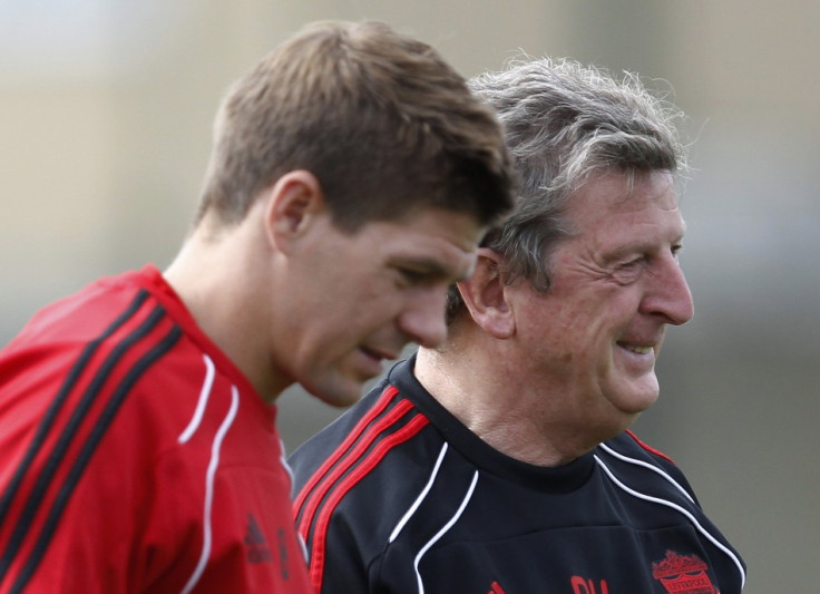Liverpool&#039;s Gerrard stands with manager Roy Hodgson