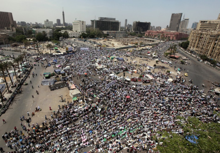 People attend Friday prayers in Tahrir Square in Cairo