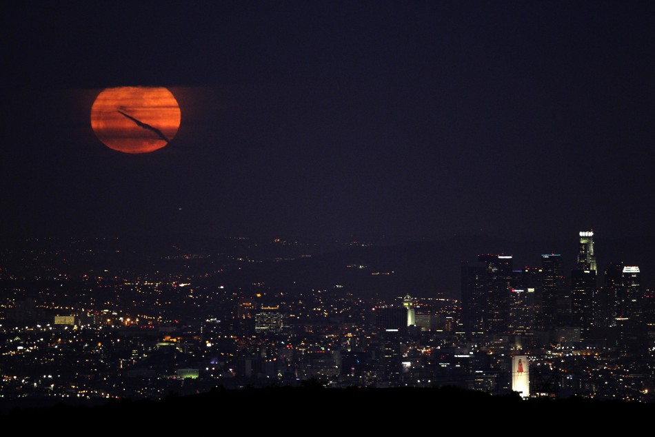 The super moon rises over downtown Los Angeles