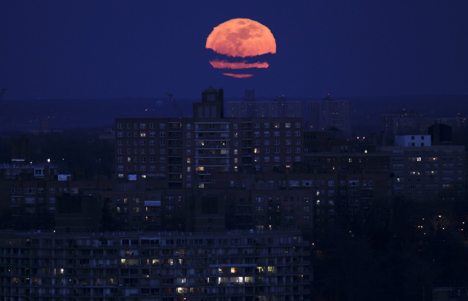 The moon rises over the Bronx section of New York City