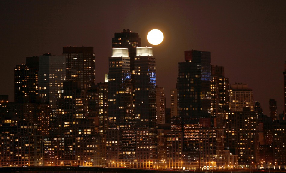 Super moon rises over the skyline of Manhattan along the Hudson River in New York