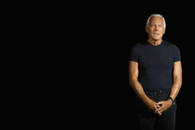 6. Italian designer Giorgio Armani acknowledges the applause at the end of his Spring/Summer 2012 women's collection during Milan Fashion Week