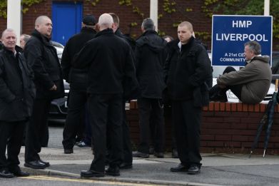 Prison officers gather outside HMP Liverpool after walking out of work  (Reuters)