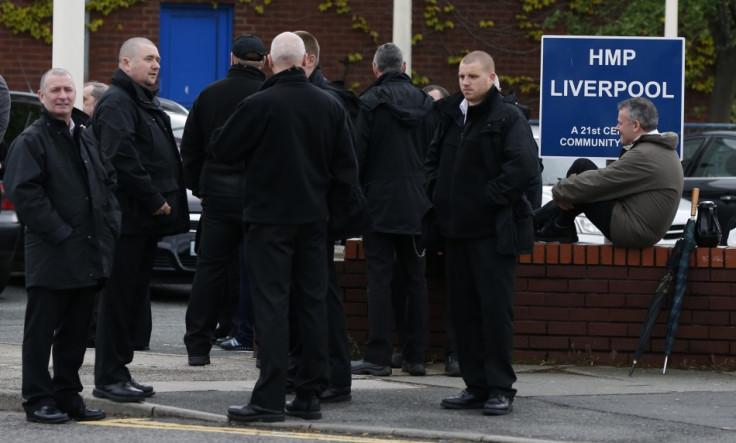 Prison officers gather outside HMP Liverpool after walking out of work  (Reuters)