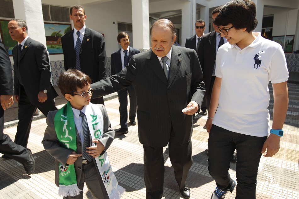 Algeria's president Bouteflika walks with nephews after casting ballot during parliamentary elections in Agiers
