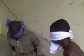 Men suspected to be members of Islamic sect Boko Haram sit blindfolded in the Nigerian city of kano