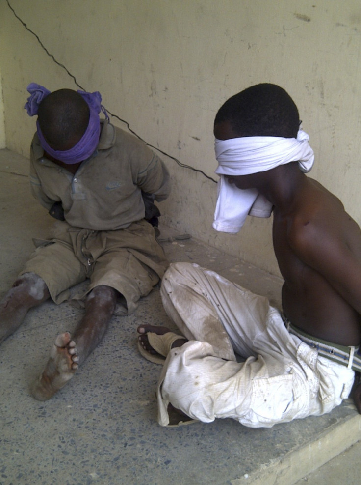 Men suspected to be members of Islamic sect Boko Haram sit blindfolded in the Nigerian city of kano