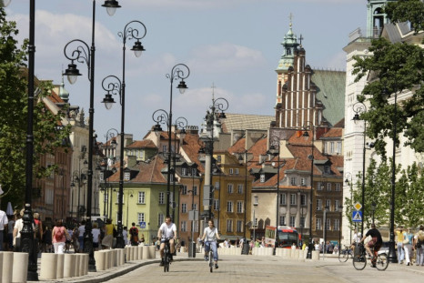 People ride bicycles through the newly renovated Krakowskie Przedmiescie near the old city of Warsaw
