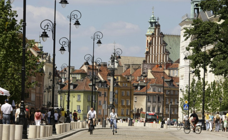 People ride bicycles through the newly renovated Krakowskie Przedmiescie near the old city of Warsaw