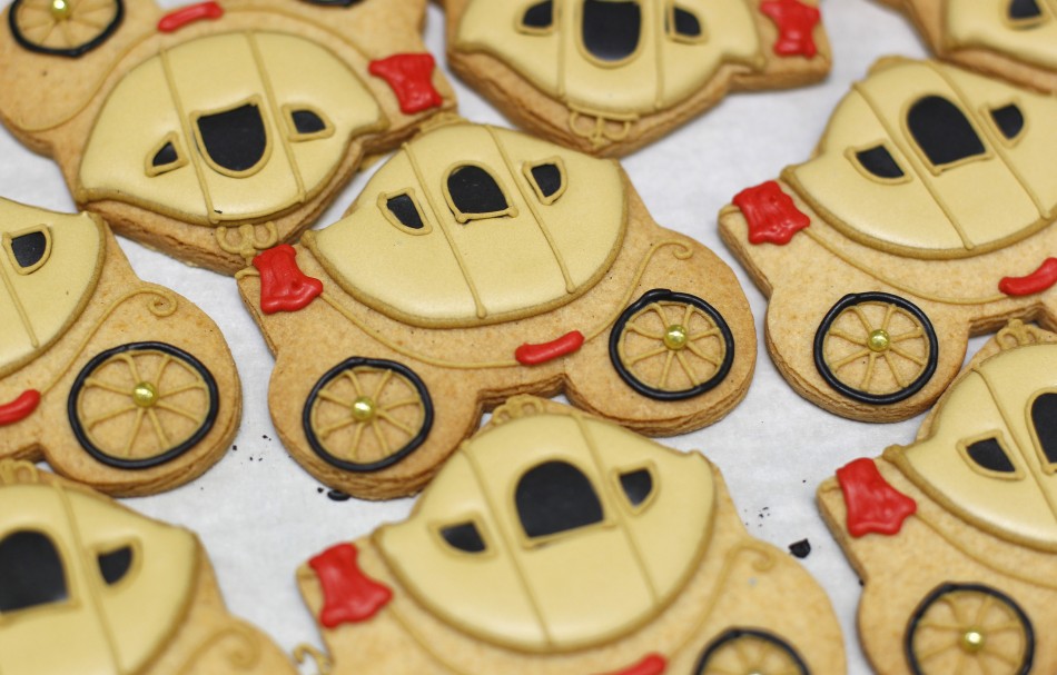 Biscuits depicting a royal carriage sit on trays at Biscuiteers in London