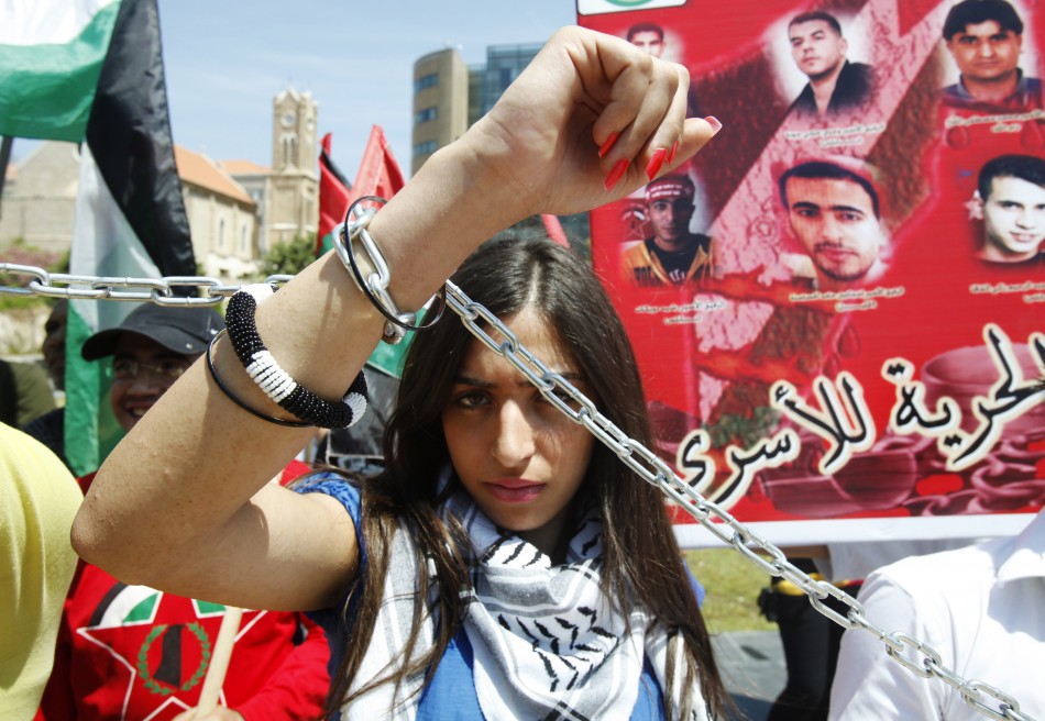 A woman of the youth Palestinian Democratic Union chains herself during a protest to mark the 64th anniversary of Nakba in Beirut