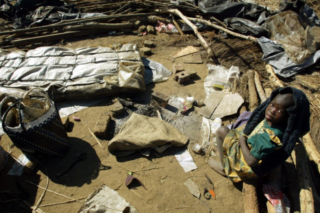 A young Zimbabwe girl sits amidst the rubble of her family's destroyed home in Porta Farm squatter camp