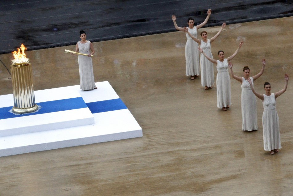 Actresses, in the role of ancient priestesses, dance during an Olympic Flame handover ceremony in Athens