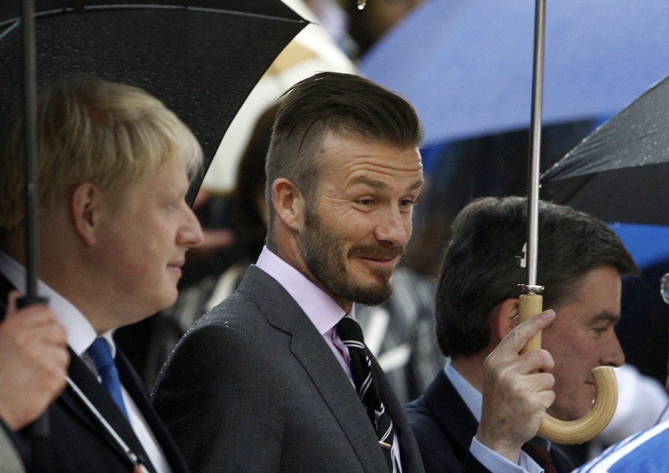 British soccer player David Beckham enters the all-marble Panathenaic stadium before an Olympic Flame handover ceremony in Athens