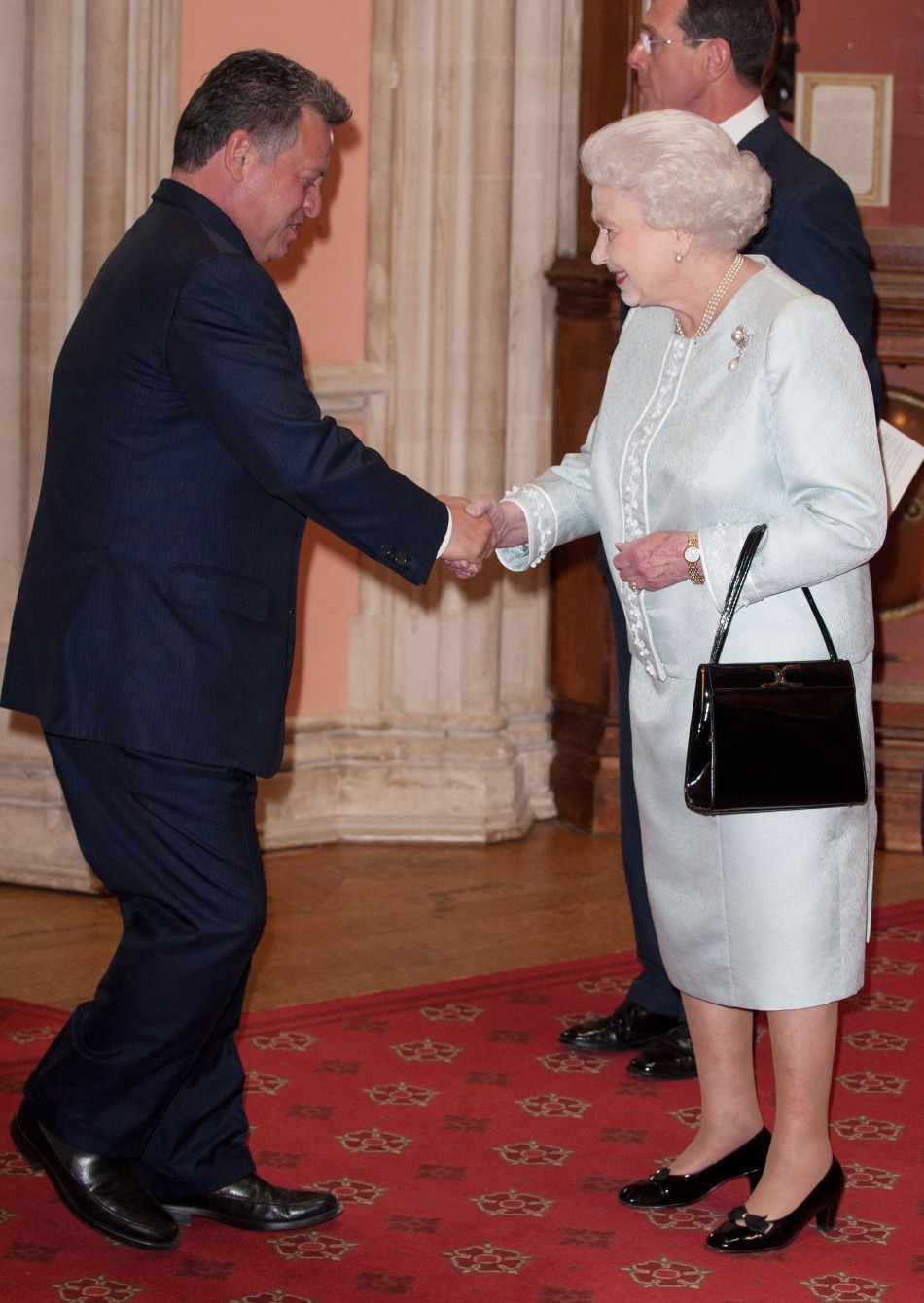 King Abdullah of Jordan is greeted by Britains Queen Elizabeth
