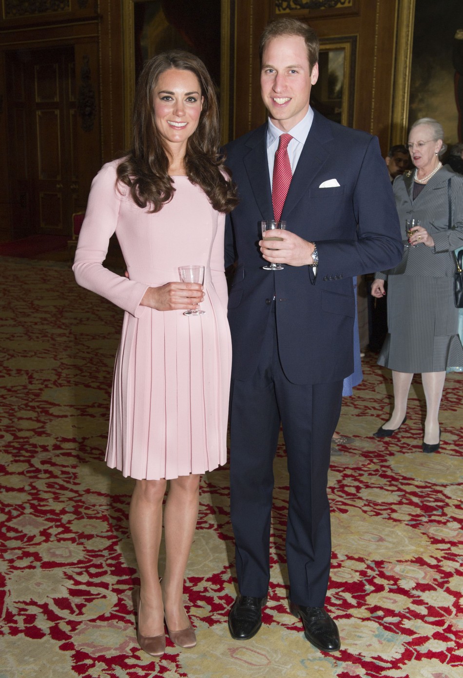 Britains Prince William and Catherine, Duchess of Cambridge pose during a reception before Queen Elizabeths Diamond Jubilee lunch at Windsor Castle in London