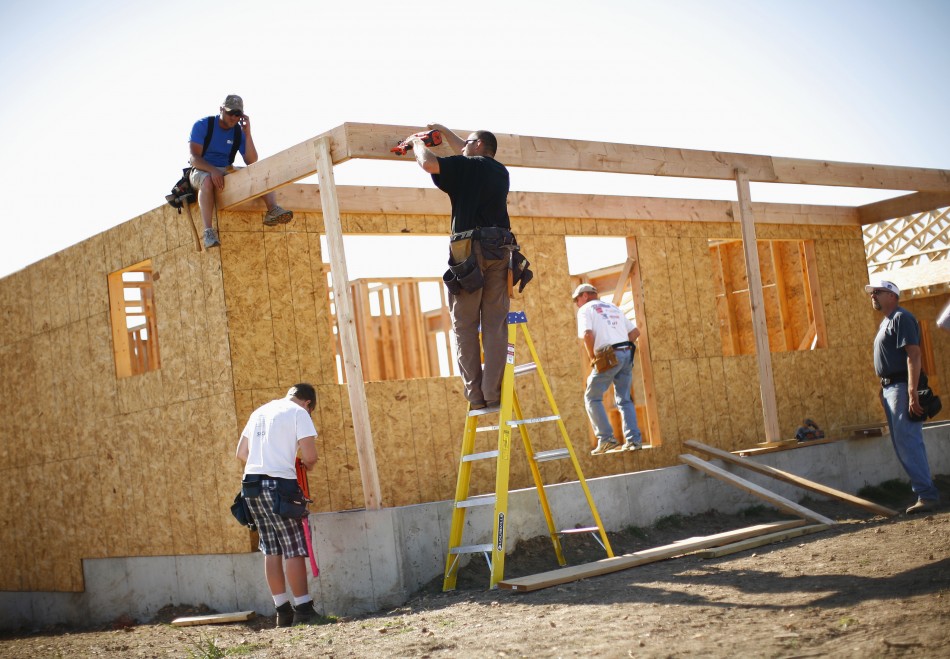 Workers construct a home in Joplin