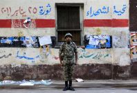An Egyptian soldier stands guard in front of a polling station in Cairo November