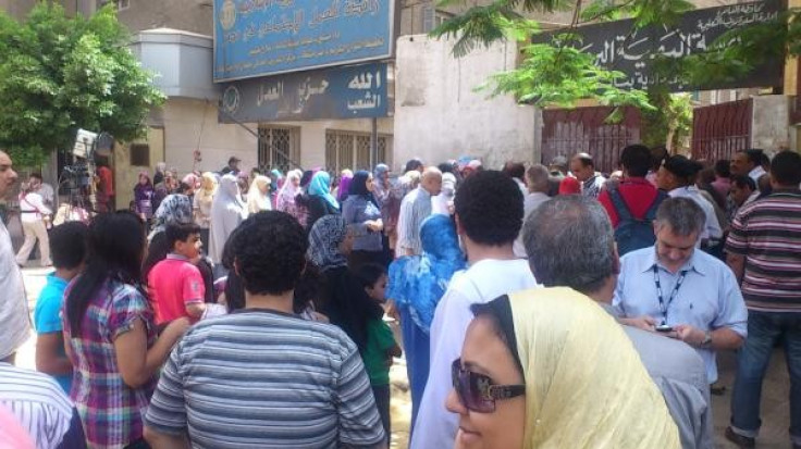 Egyptians queuing at a polling sEgyptians are heading to the polls for their first free presidential elections, 15 months after mass protests ousted former leader Hosni Mubarak
