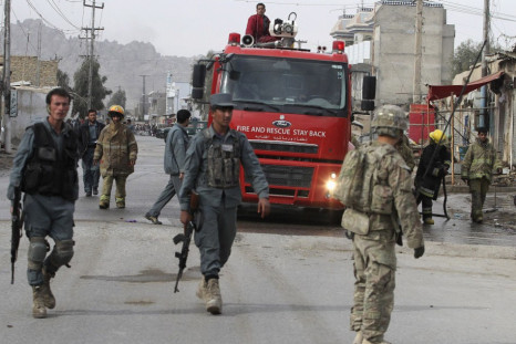 Afghan police officers and foreign soldiers arrive at the site of a suicide attack in Kandahar province in Januray 2012.